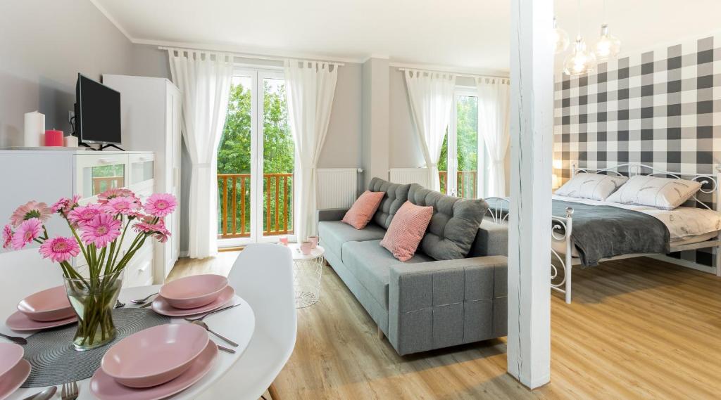 a living room with a couch and a table at Apartament na Wierchu zarezerwuj na podhalami pl in Bukowina Tatrzańska