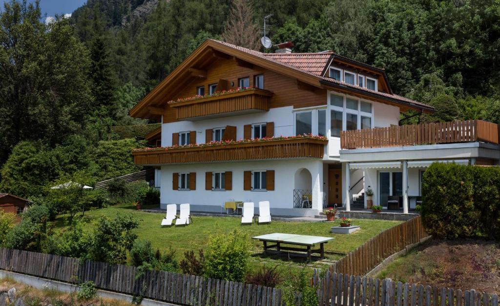 a house with a picnic table in front of it at Haus Aron in Brunico