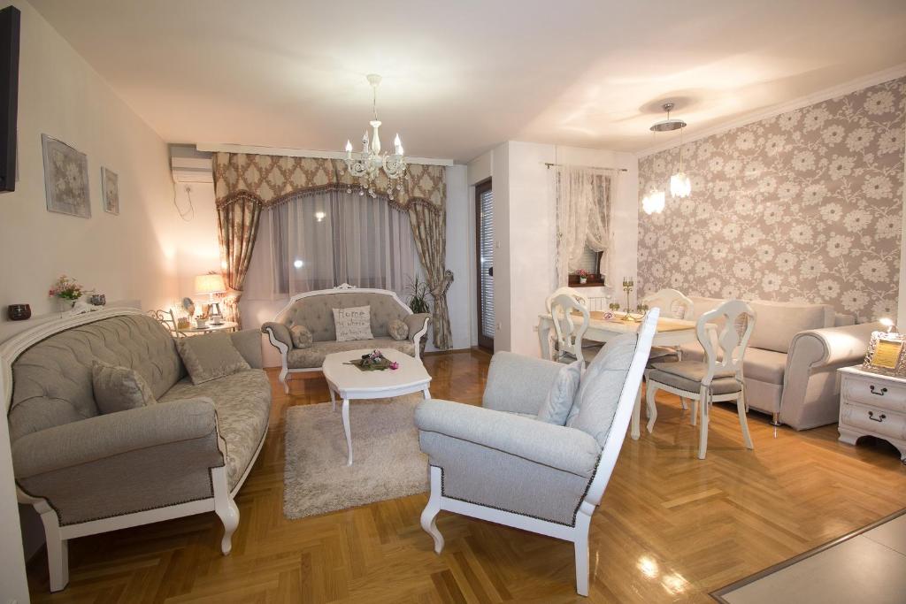 a living room with a couch and chairs and a table at Apartment Barby - Deluxe in Banja Luka