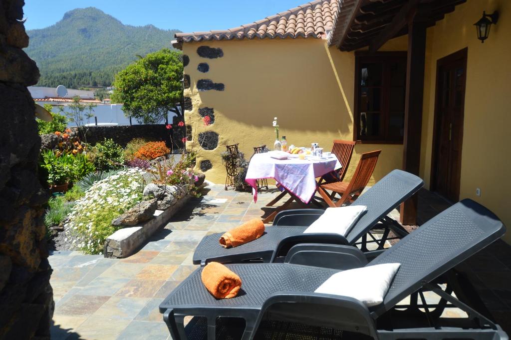 a patio with a table and chairs with a view of a mountain at Ismail in El Paso