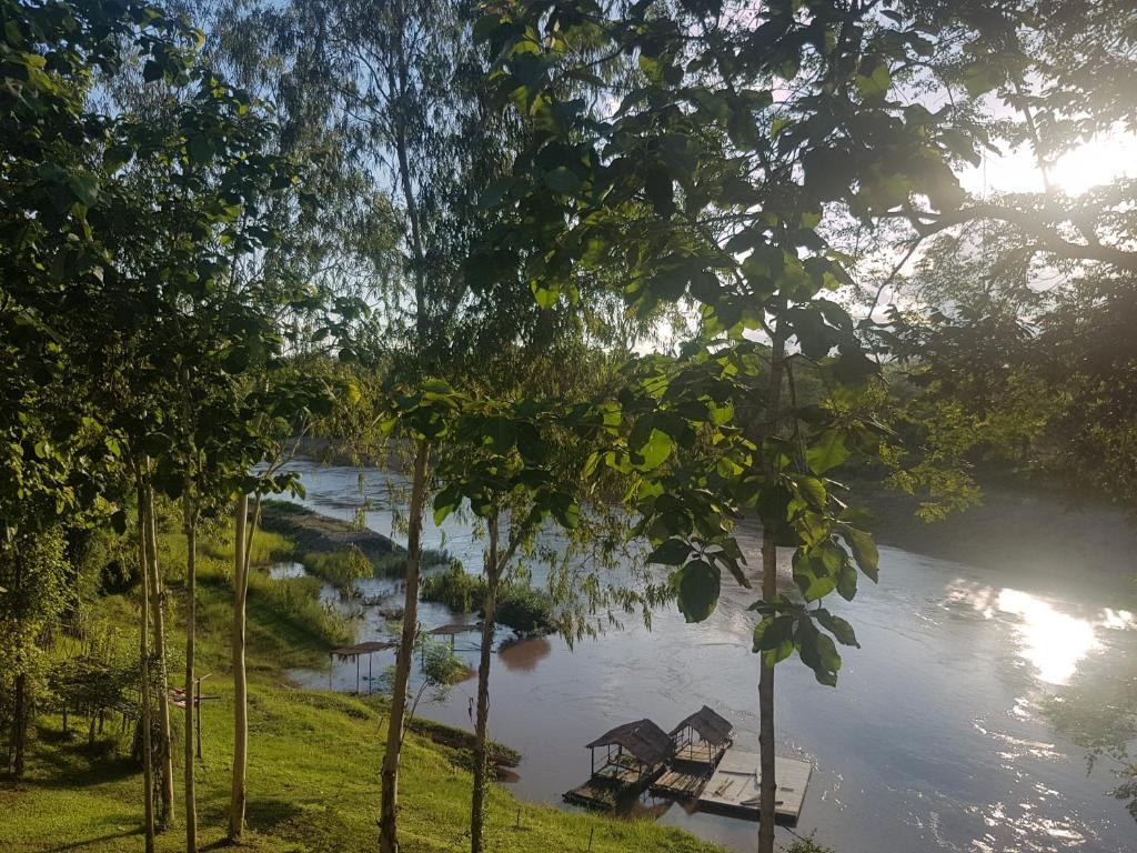 Un río con una casa en medio. en Nan De Panna Resort and Spa, en Nan