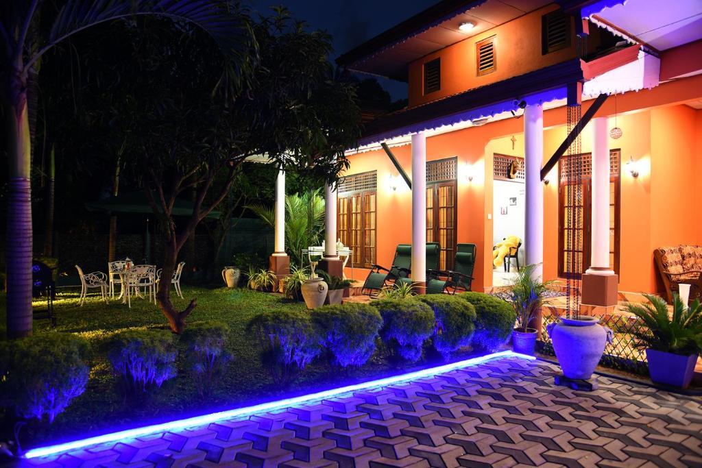 a house with a lit up garden at night at One and Only Apartment in Negombo