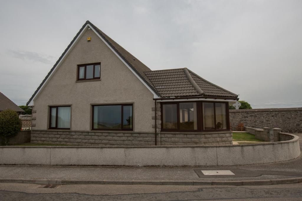 a house with a pitched roof on a street at GOLFVIEW 4 in Buckie