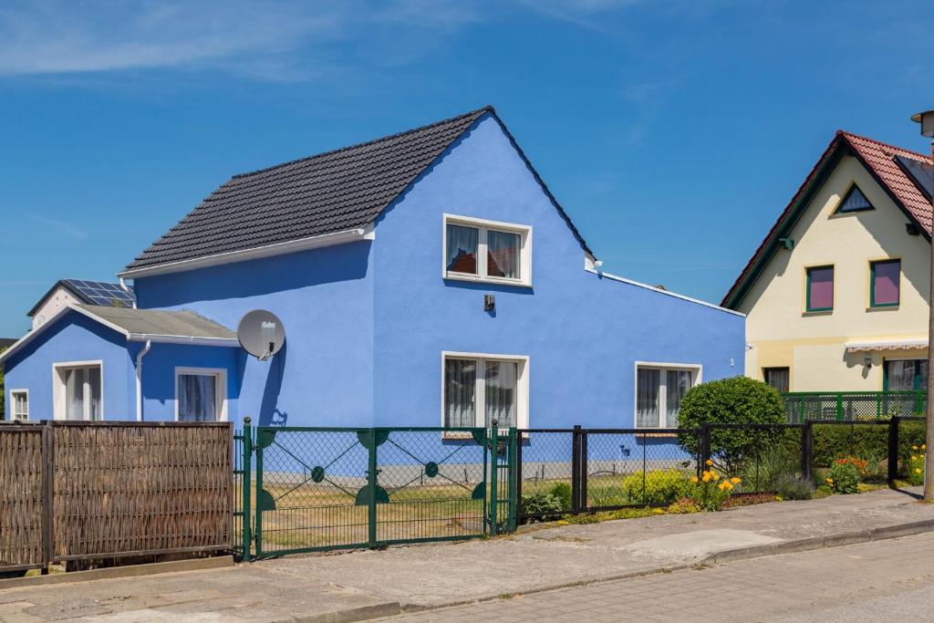 a blue house with a black roof at Haus Frieda in Ostseebad Koserow
