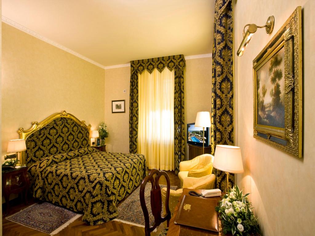 Кровать или кровати в номере Hotel Vittoria