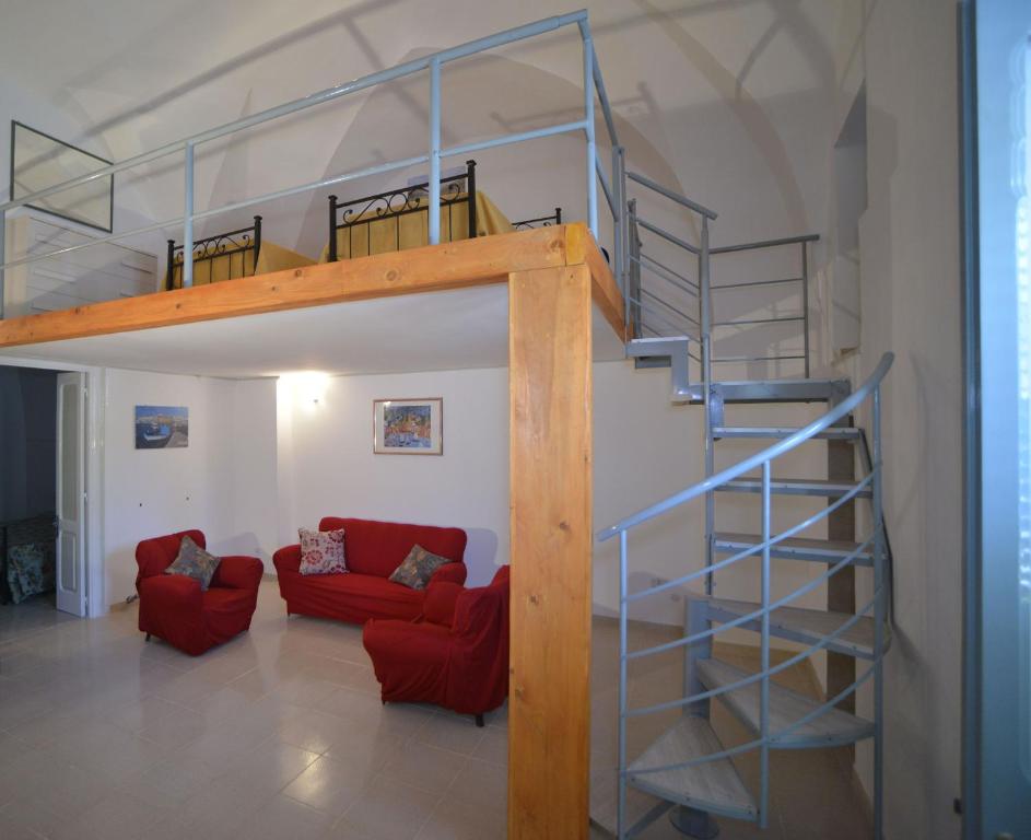 a living room with a loft bed and a staircase at Casa Vienna in Salice Salentino