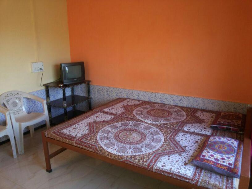 a bedroom with a bed with a rug on it at Greenveela Resort in Devgarh