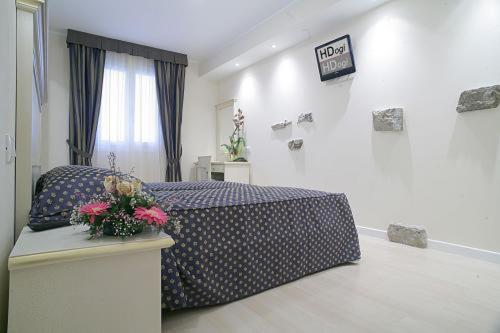 Postel nebo postele na pokoji v ubytování Hotel Ai Dogi