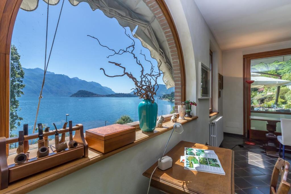 a room with a window with a view of the water at Villa Gilda - Griante in Griante Cadenabbia