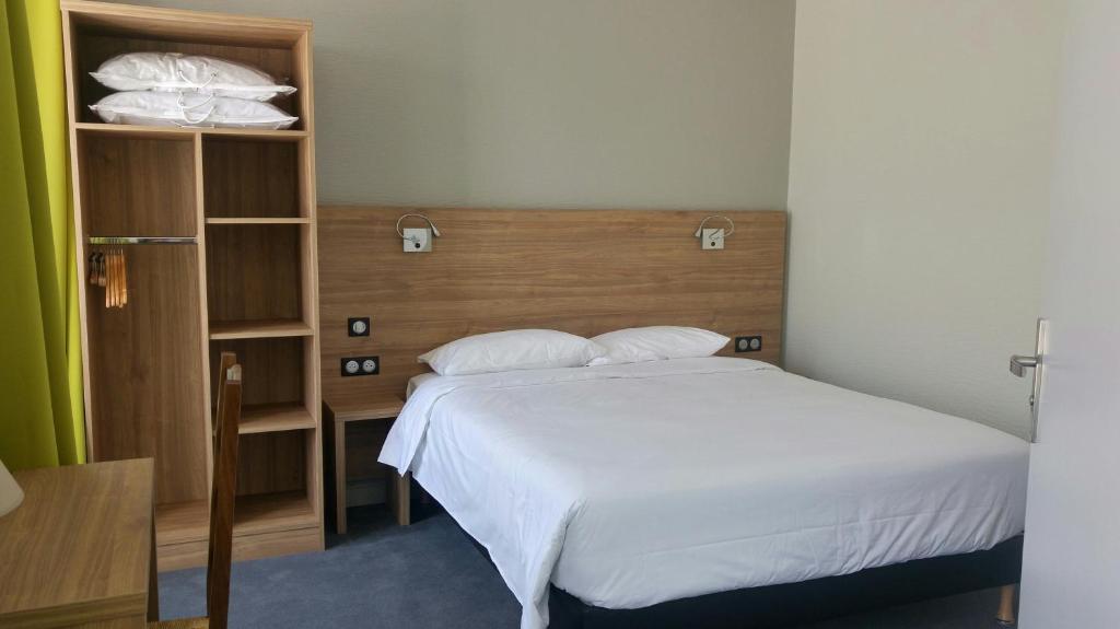 Postel nebo postele na pokoji v ubytování Hôtel Le Verger