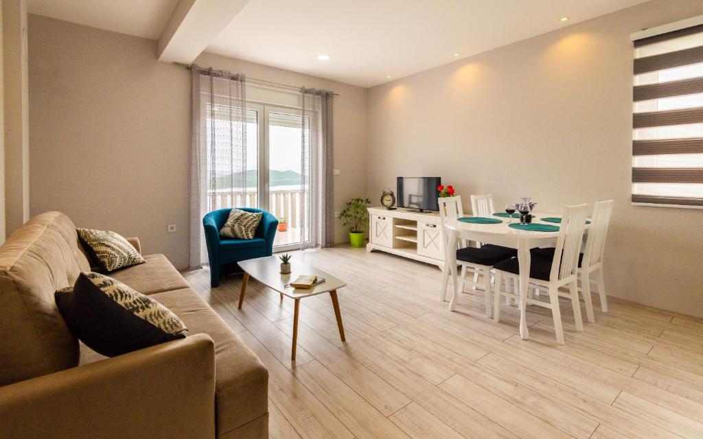 un soggiorno con divano e tavolo di Apartments Leona a Neum