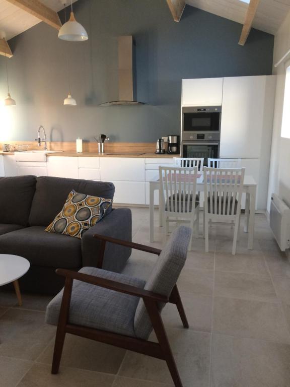 a living room with a couch and a table at La grange in Machecoul