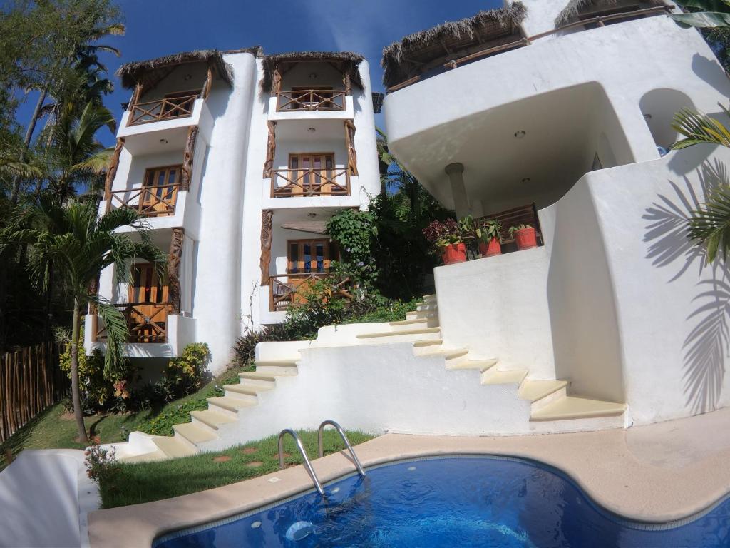 an external view of a building with a swimming pool at Mar y Sueños in Sayulita