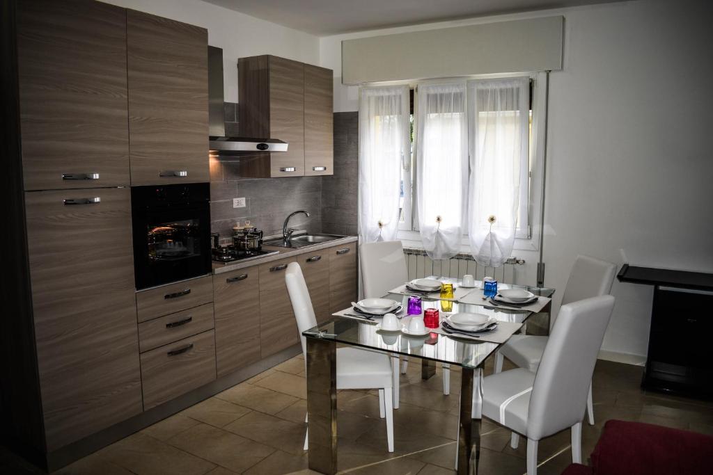 a kitchen with a table and white chairs in a room at Valsugana in Mestre