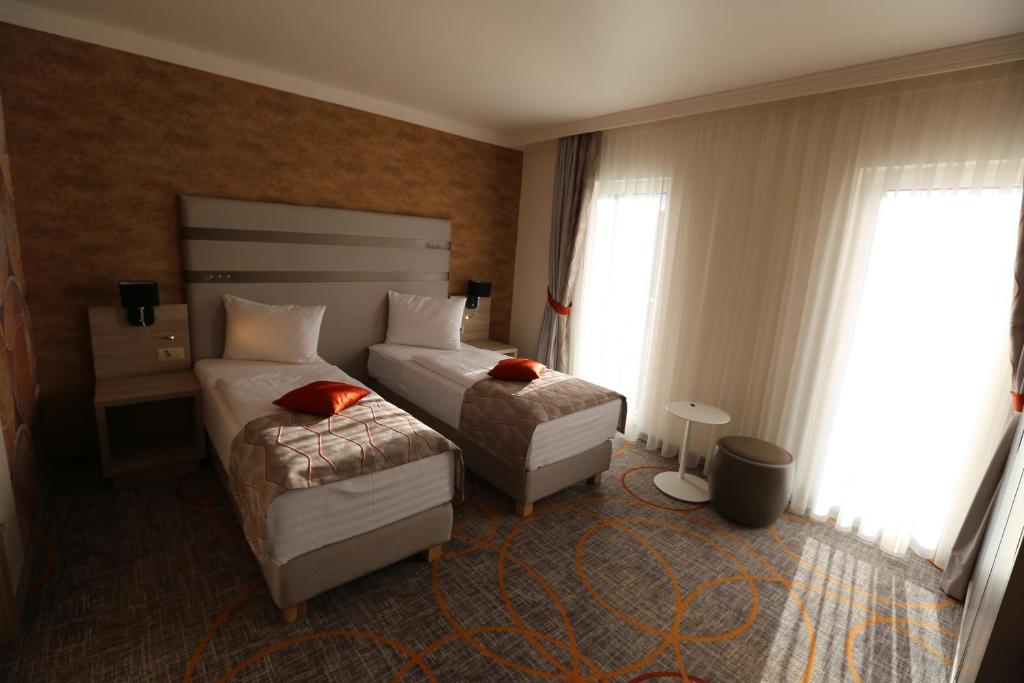 Postel nebo postele na pokoji v ubytování Hotel Baril