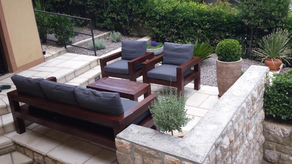 a patio with two chairs and a table and a couch at Apartment Iva in Novi Vinodolski