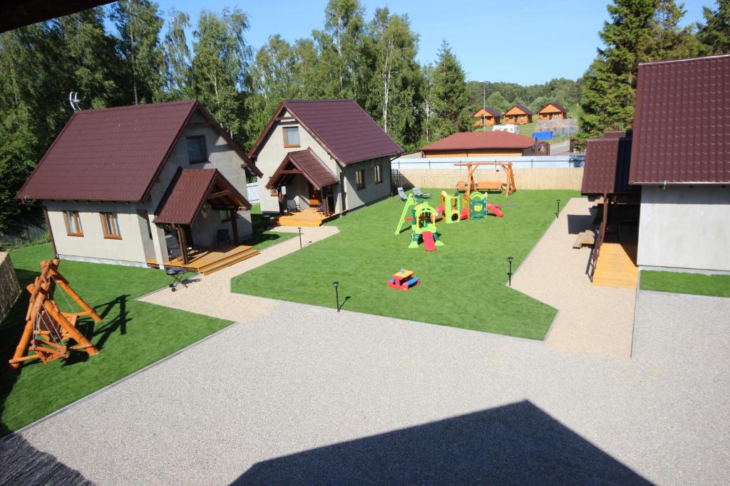 a model of a backyard with a playground at Domki TORTUGA Debki in Dębki