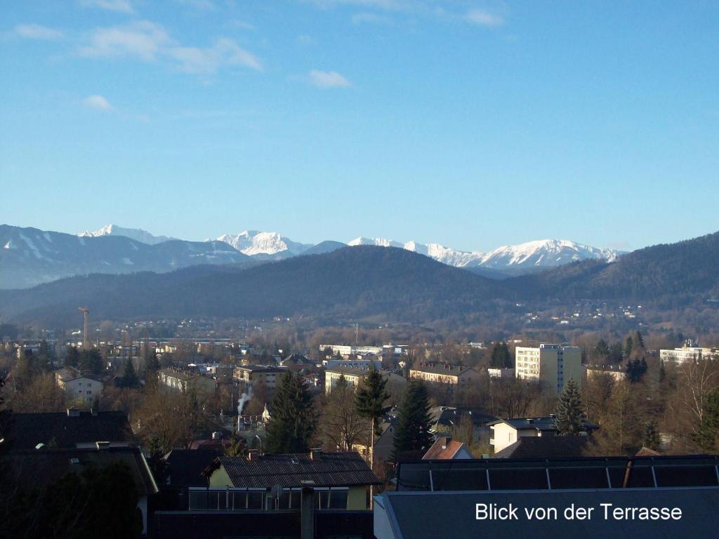 a view of a city with snow covered mountains at Riedl Gästewohnung in Klagenfurt