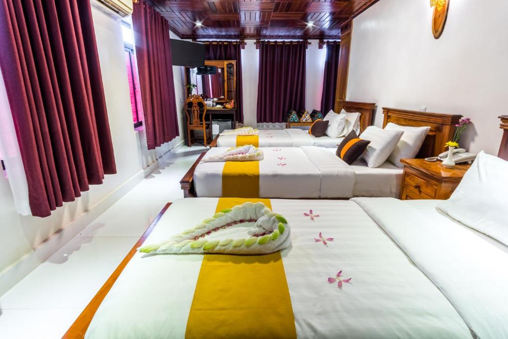 Postel nebo postele na pokoji v ubytování Hello Cambodia Boutique
