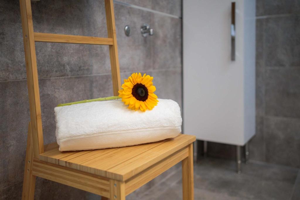 a sunflower sitting on a table in a bathroom at Otium in Kaštela