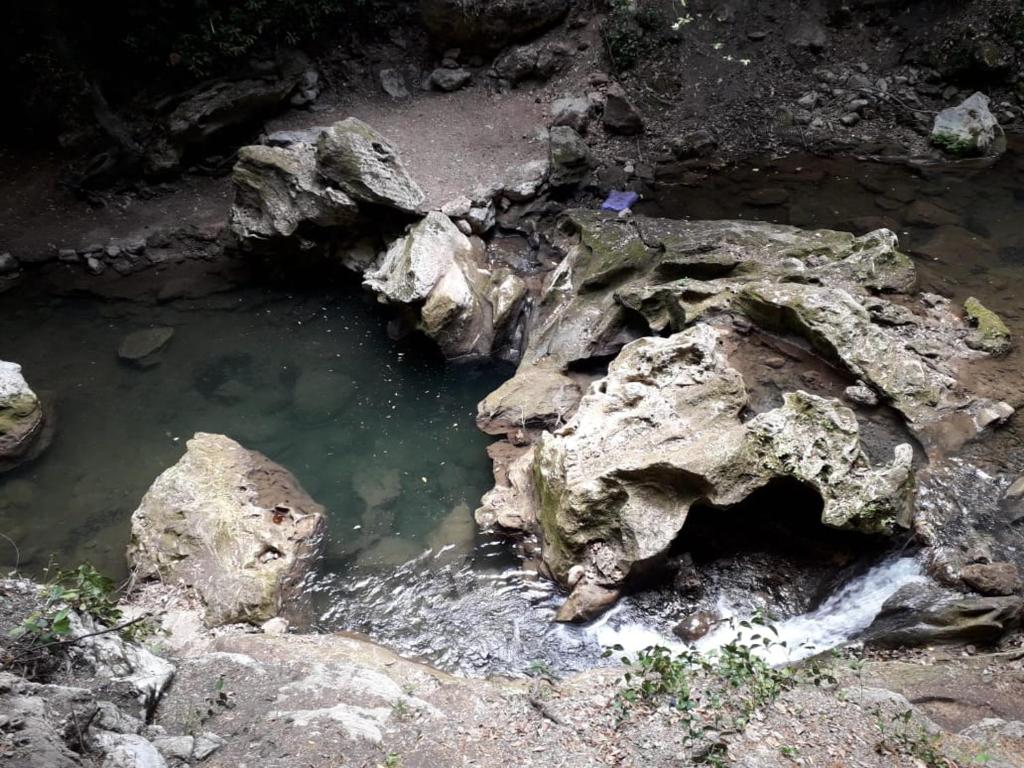 a group of rocks and water in a cave at Hostal La Joya in Chefchaouene