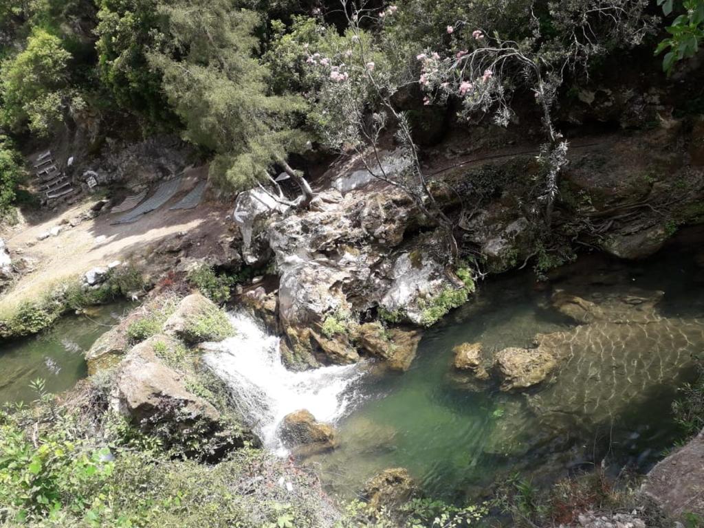 an aerial view of a river with a waterfall at Hostal La Joya in Chefchaouene
