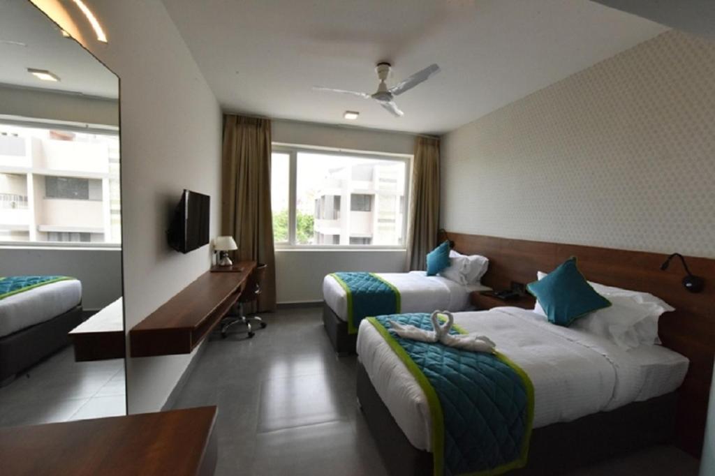 Postel nebo postele na pokoji v ubytování Vivid A Boutique Hotel