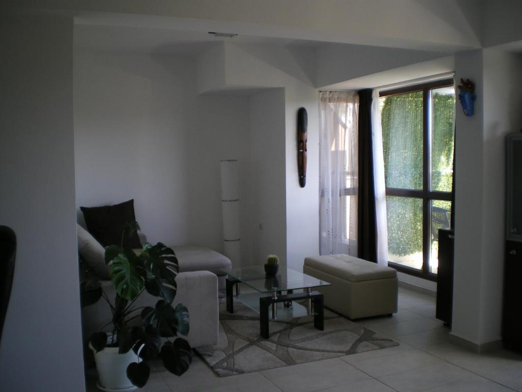 a living room with a couch and a table at Park View Apartment Plovdiv with Parking in Plovdiv