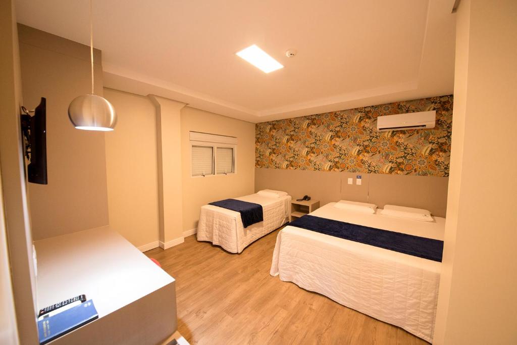 Postel nebo postele na pokoji v ubytování Hiber Hotel - Acesso a Chapecó