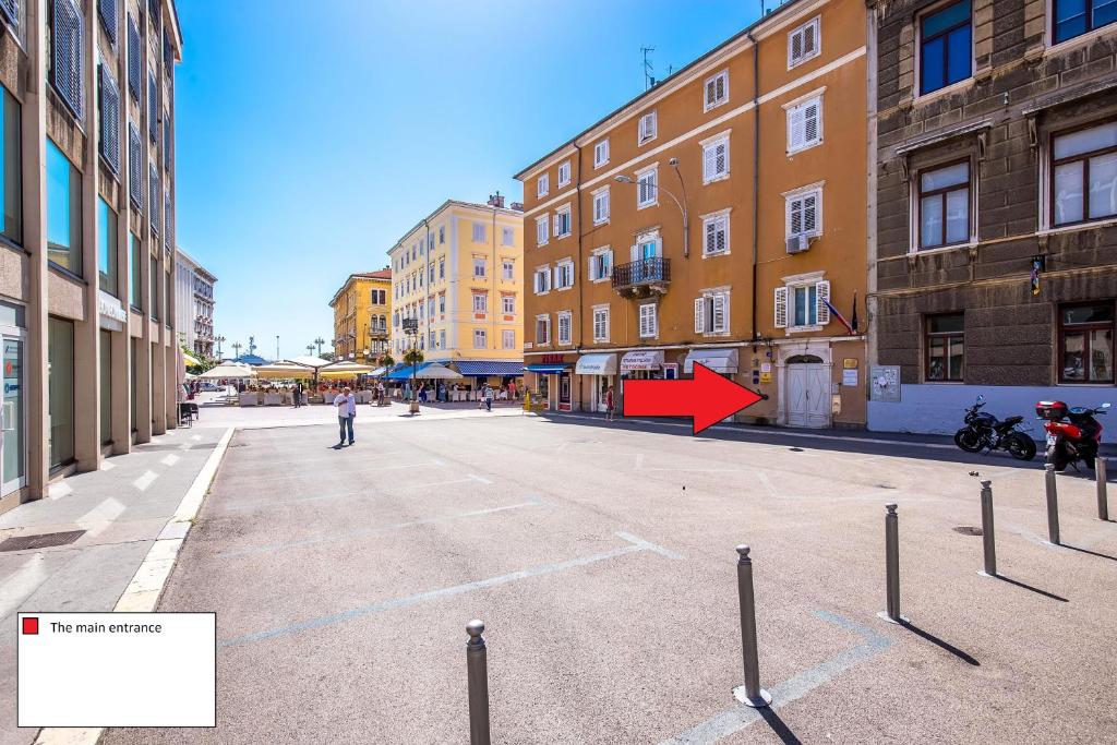 an empty street in a city with a red arrow at Main Street apartments in Rijeka