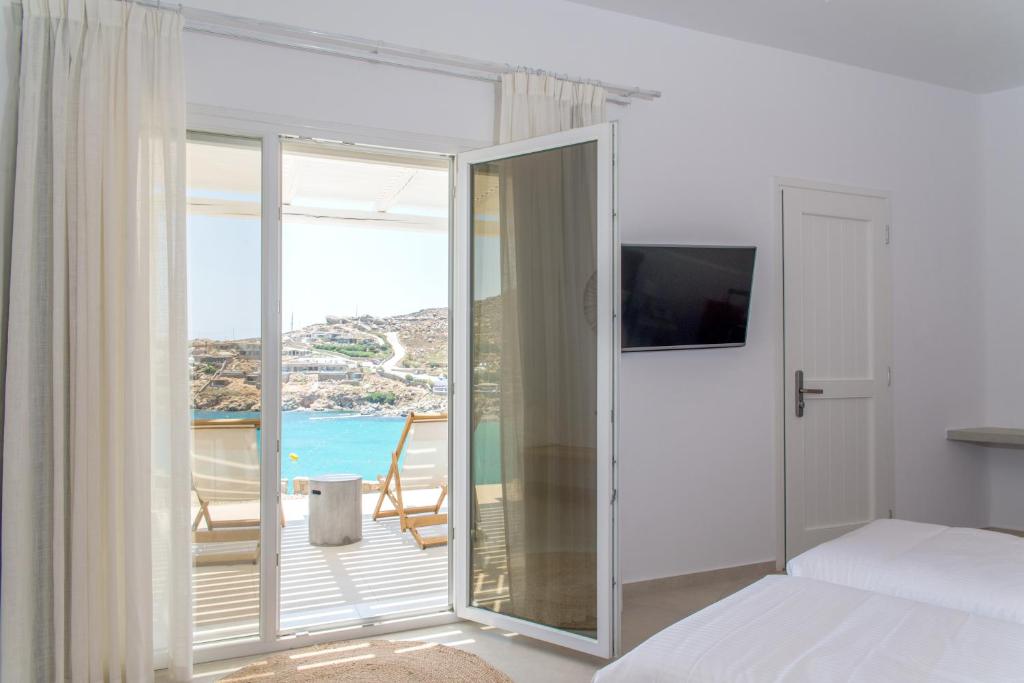 a bedroom with a bed and a view of the ocean at Super Paradise Hotel in Super Paradise Beach