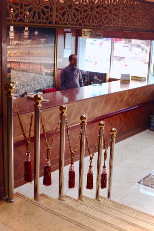 a stair railing with bells on it in a restaurant at Emirates Plaza Hotel in Ajman 