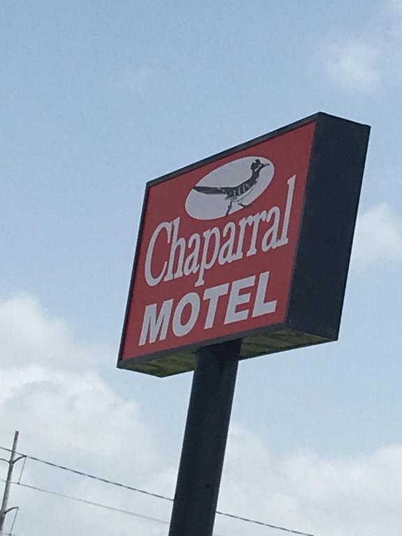 a sign for a chappal motel on a pole at Chaparral Motel in Port Lavaca