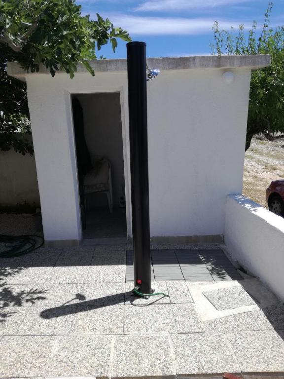 a black pole sitting in the doorway of a building at Apartment Marta in Ražanac