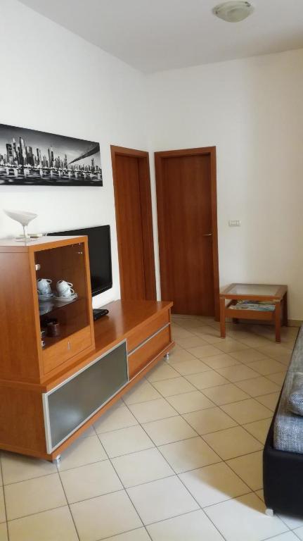 a living room with a tv and a couch at Apartment Možina in Koper