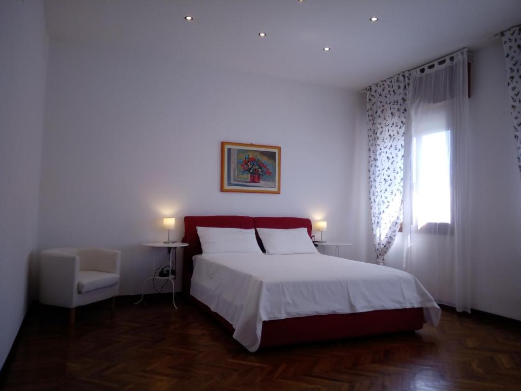 a bedroom with a large bed and a window at Polly House in Treviso