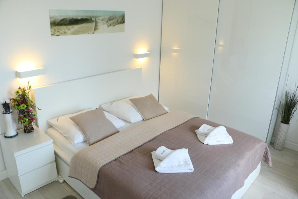 Postel nebo postele na pokoji v ubytování Apartamenty Feniks & Pegaz