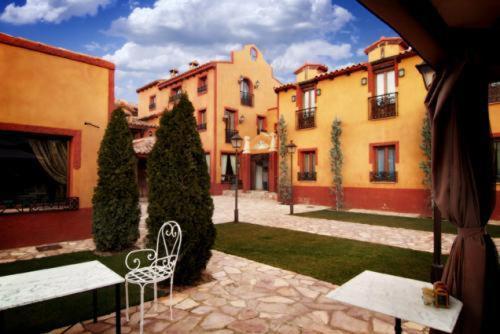 a courtyard with a white bench and some buildings at Rincón de Navarrete in Calamocha