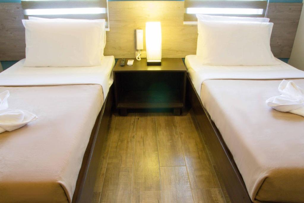 Postel nebo postele na pokoji v ubytování Sheridan Boutique Hotel