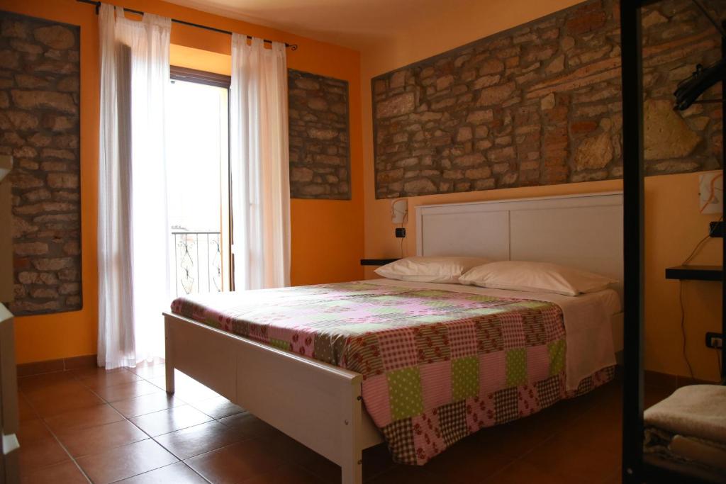 a bedroom with a bed in front of a window at La Casa Di Valerio in Montabone