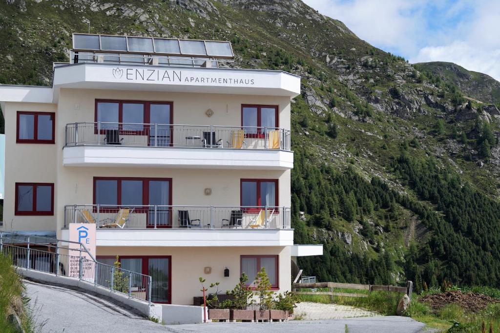 a building on the side of a mountain at Apartmenthaus Enzian Hochsölden in Sölden