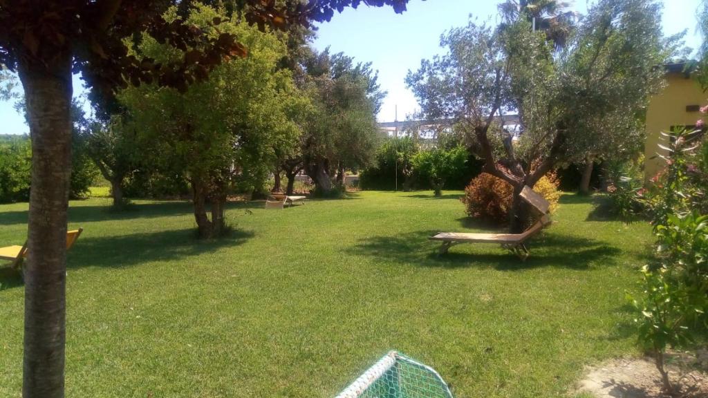 a park with a bench in the grass at B&B Da Fiorò in Massignano