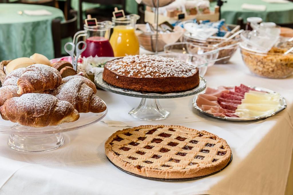 a table topped with different types of bread and pastries at Holiday in Milano Marittima