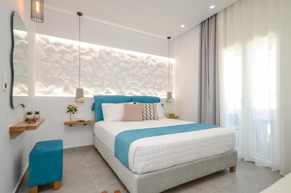 1 dormitorio con 1 cama de color azul y blanco en 3 Wishes en Naxos
