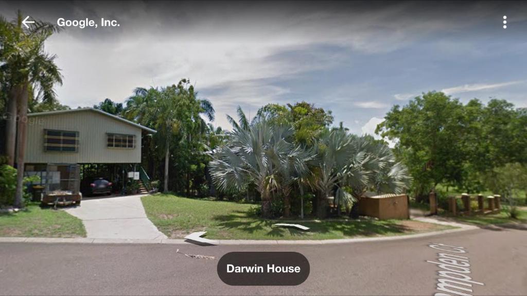 a house on the side of a street with a driveway at Darwin House in Palmerston