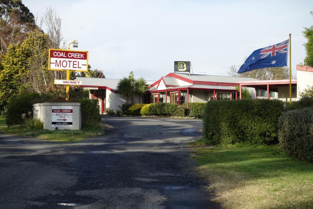 a motel sign in front of a motel at Coal Creek Motel in Korumburra