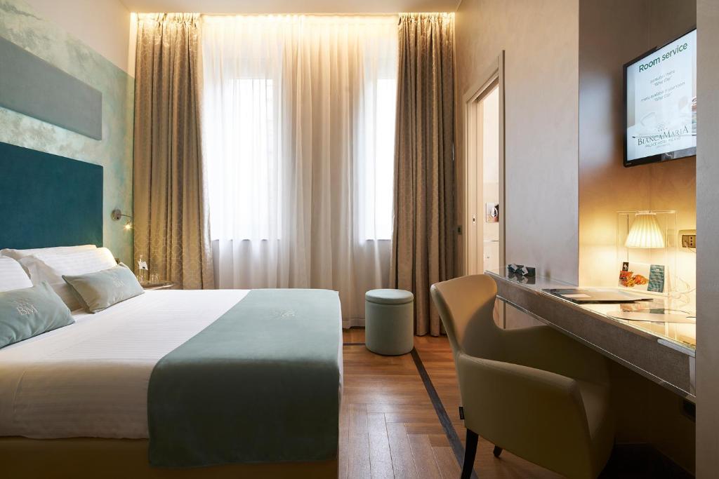 Postel nebo postele na pokoji v ubytování Bianca Maria Palace Hotel