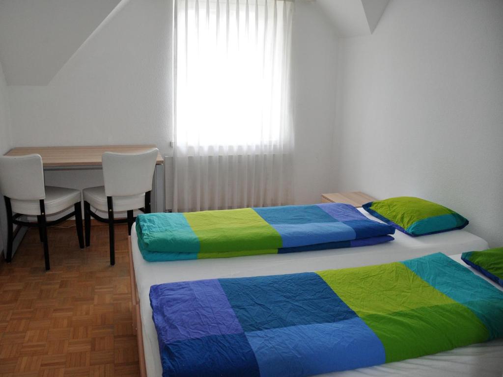 Postel nebo postele na pokoji v ubytování August Restaurant Hotel