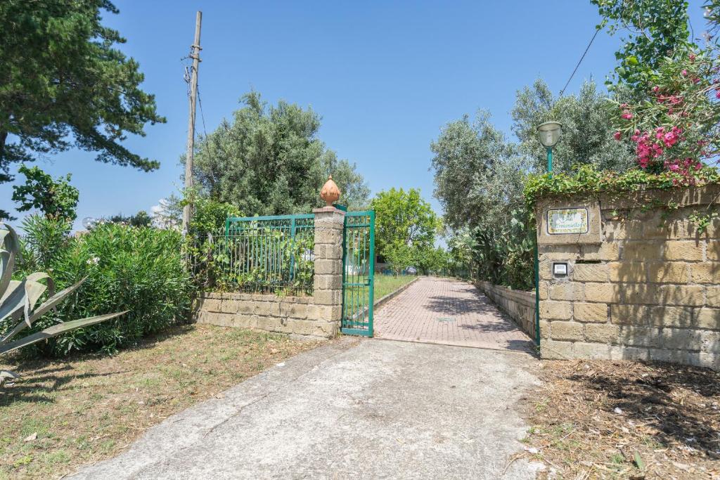 a gate to a garden with a driveway at Villa Troianiello in Carano