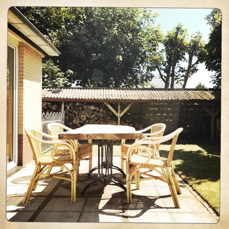 a wooden table and chairs on a patio at De Munnik in Camperduin